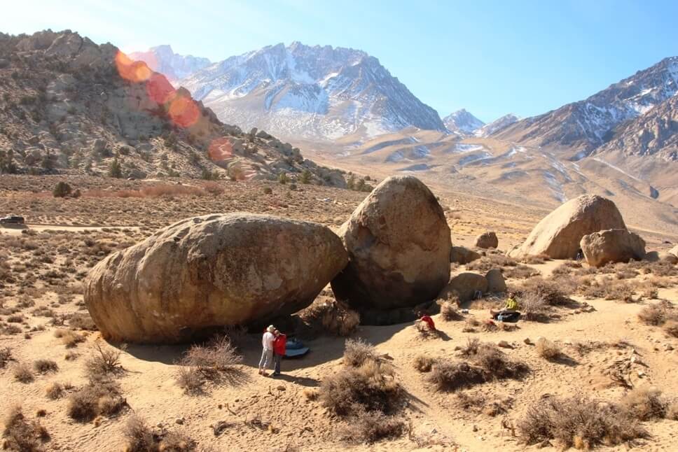 bishop bouldering 乾燥した山岳風景の中の大きな岩塊と、そのふもとにいる人々